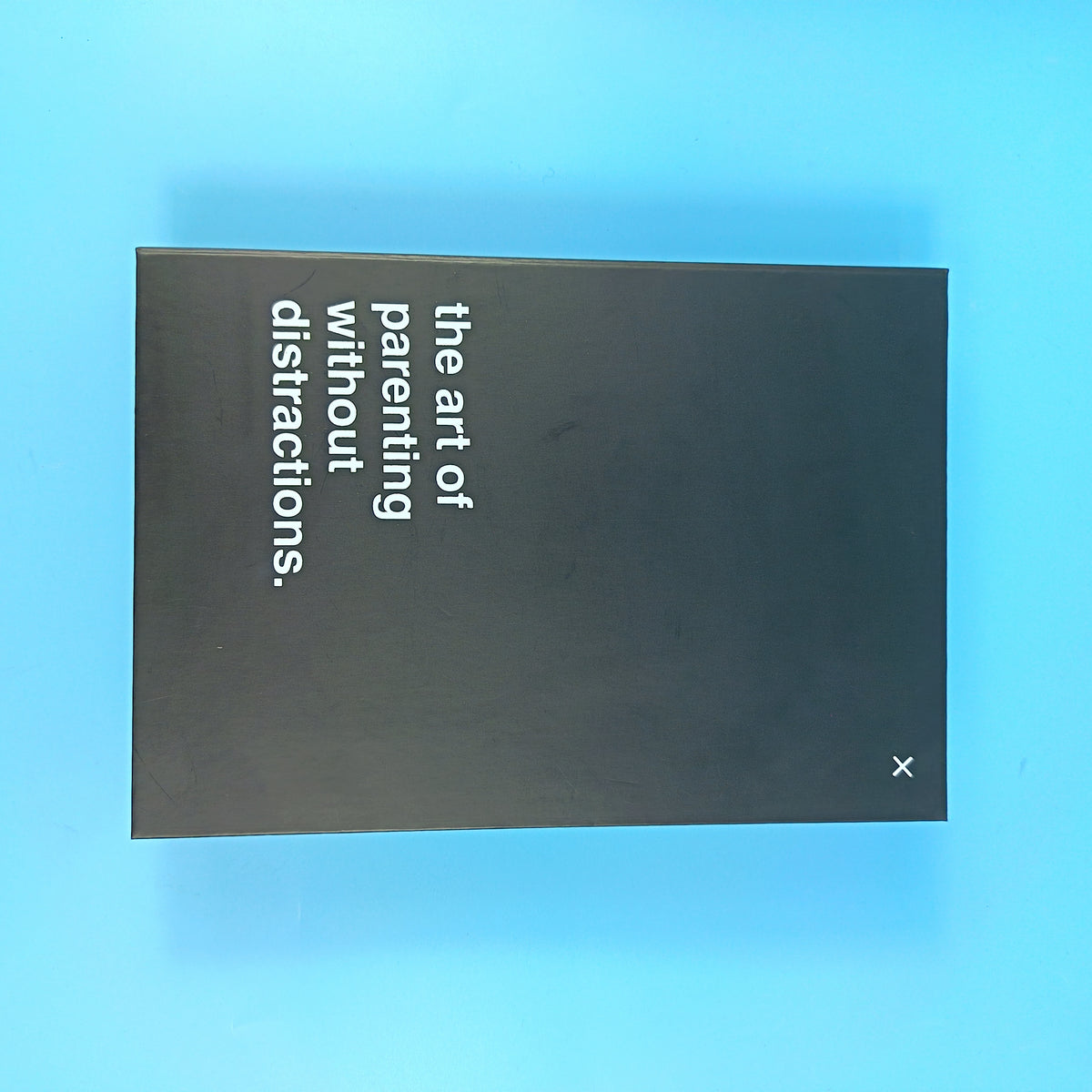 Book Decoy closed cover — matte black hardcover with the title 'the art of parenting without distractions'